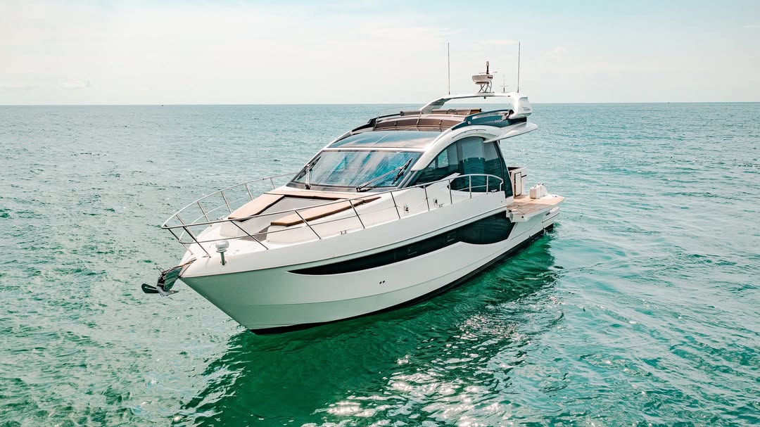 Aerial view of the catamaran yacht cruising the turquoise sea